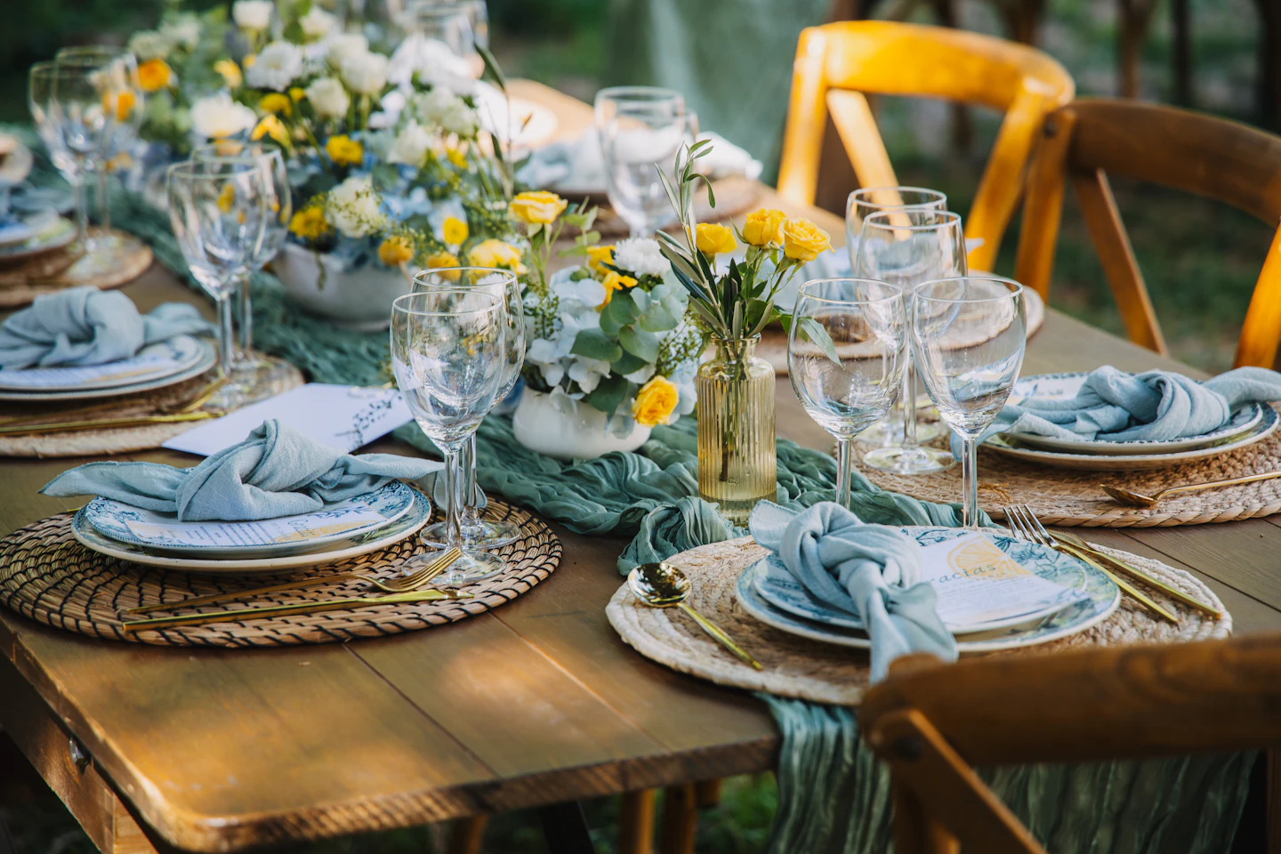 Flowers and glassware on an outdoor celebration table